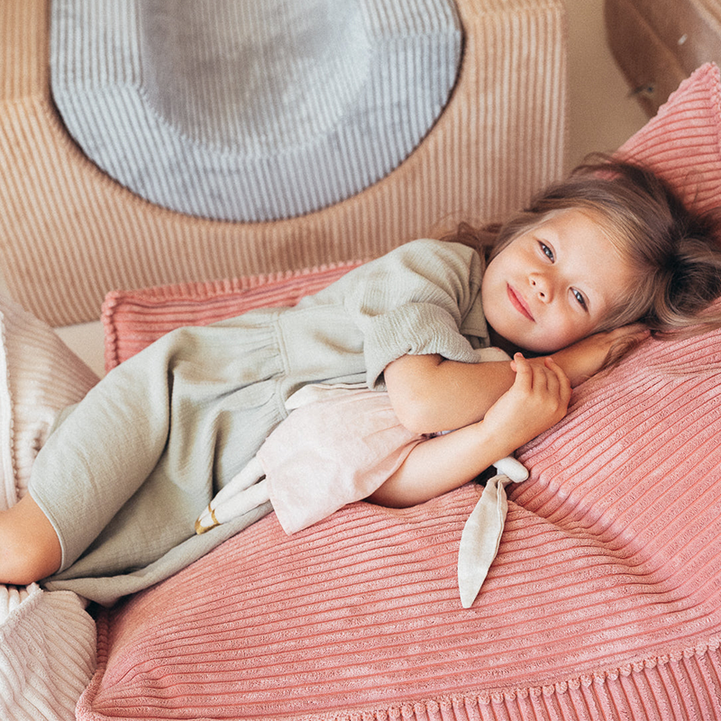  Wigiwama Sitzsack Beanbag in der Farbe Pink Mousse mit Mädchen, das darauf liegt. 